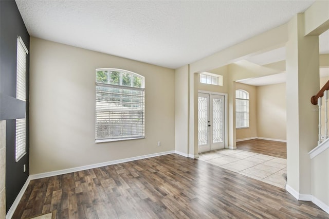 297 Beacon Pointe Dr, Ocoee, FL 34761 - entrance foyer with wood finished floors, stairs, and a textured ceiling