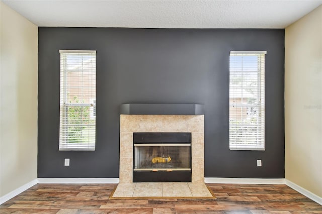 297 Beacon Pointe Dr, Ocoee, FL 34761 - detailed view of wood finished floors and a tiled fireplace