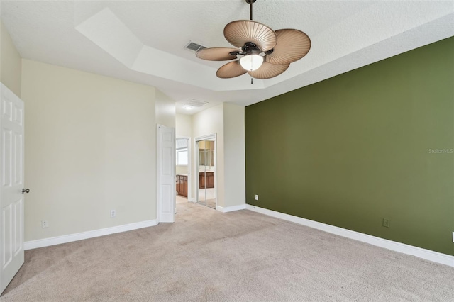 297 Beacon Pointe Dr, Ocoee, FL 34761 - unfurnished room with light colored carpet, ceiling fan, and a raised ceiling