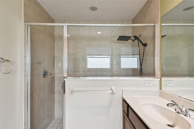 297 Beacon Pointe Dr, Ocoee, FL 34761 - full bathroom with vanity, a textured ceiling, and a stall shower