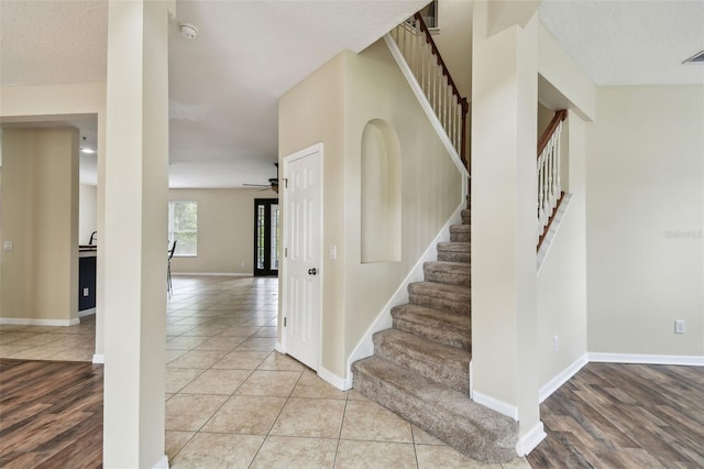 297 Beacon Pointe Dr, Ocoee, FL 34761 - stairway with tile patterned flooring and ceiling fan