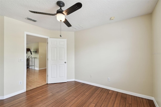297 Beacon Pointe Dr, Ocoee, FL 34761 - spare room with a ceiling fan, wood finished floors, a textured ceiling, and a smoke detector