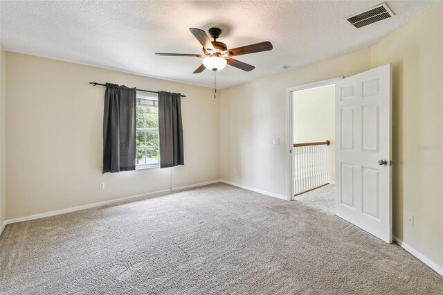 297 Beacon Pointe Dr, Ocoee, FL 34761 - empty room featuring carpet flooring, ceiling fan, and a textured ceiling