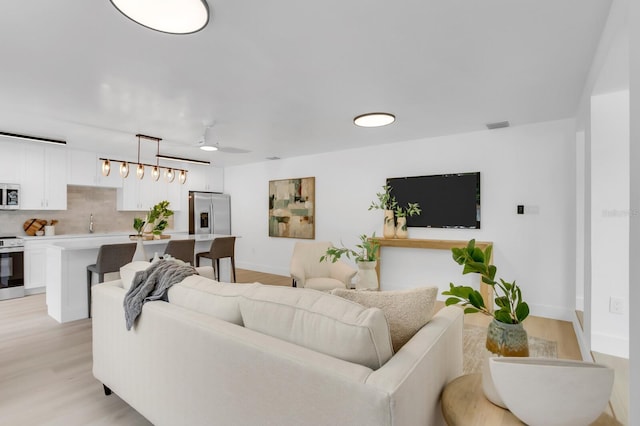 3381 19th Pl SW, Largo, FL 33774 - living area featuring light wood-style floors and ceiling fan