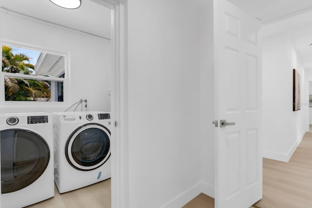 3381 19th Pl SW, Largo, FL 33774 - washroom with washing machine and dryer and light wood-style floors