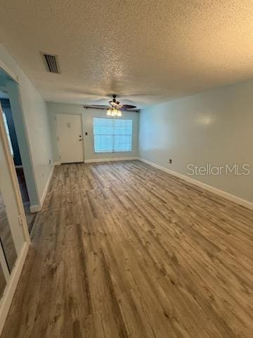 1020 85th Ave N Unit 223, Saint Petersburg, FL 33702 - unfurnished room featuring wood finished floors, a textured ceiling, and ceiling fan