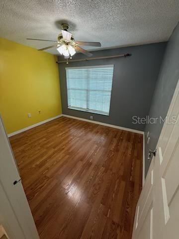 1020 85th Ave N Unit 223, Saint Petersburg, FL 33702 - spare room with wood finished floors, a textured ceiling, and ceiling fan