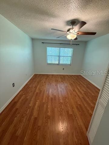 1020 85th Ave N Unit 223, Saint Petersburg, FL 33702 - unfurnished room featuring a ceiling fan, wood finished floors, and a textured ceiling