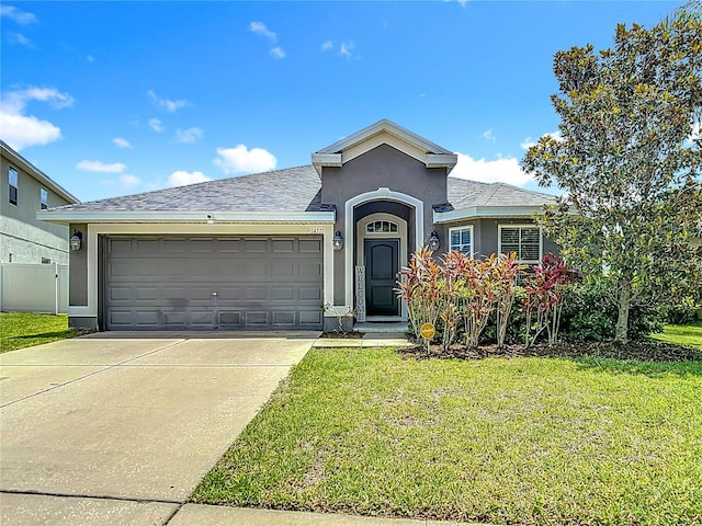 14371 Edinburgh Moor Dr, Wimauma, FL 33598 - ranch-style house with stucco siding, concrete driveway, an attached garage, and a shingled roof