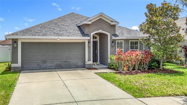 14371 Edinburgh Moor Dr, Wimauma, FL 33598 - view of front of property featuring a shingled roof, an attached garage, concrete driveway, stucco siding, and a front yard