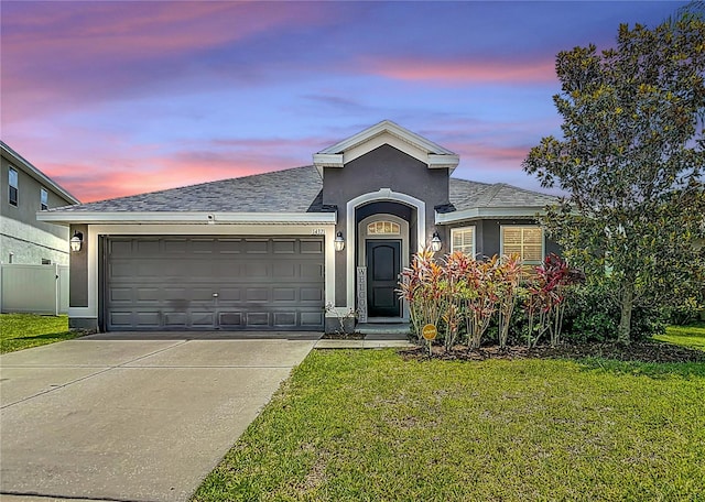 14371 Edinburgh Moor Dr, Wimauma, FL 33598 - view of front facade with concrete driveway, a garage, stucco siding, and a shingled roof
