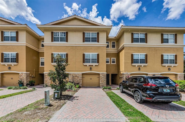 5030 Herring Ct, New Port Richey, FL 34652 - multi unit property with driveway, stucco siding, a garage, and stone siding