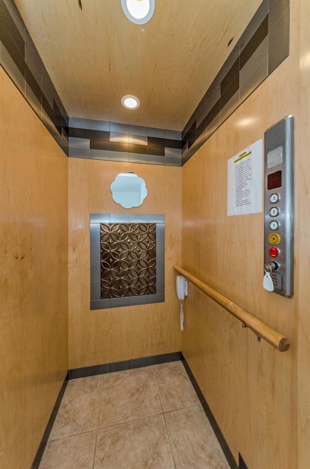 5030 Herring Ct, New Port Richey, FL 34652 - hall with tile patterned flooring and elevator