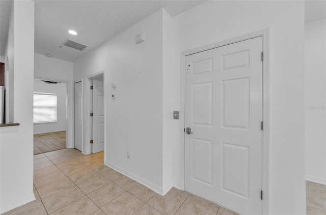 5030 Herring Ct, New Port Richey, FL 34652 - hall with light tile patterned floors and recessed lighting