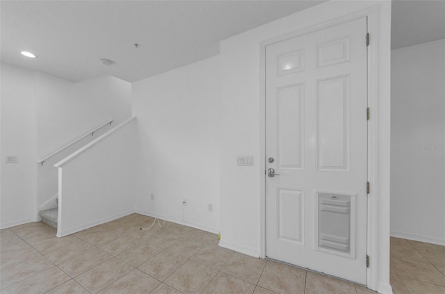 5030 Herring Ct, New Port Richey, FL 34652 - spare room with light tile patterned flooring, stairs, and recessed lighting