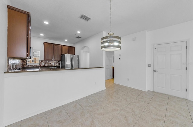 5030 Herring Ct, New Port Richey, FL 34652 - kitchen with stainless steel fridge with ice dispenser, dark countertops, decorative backsplash, recessed lighting, and decorative light fixtures