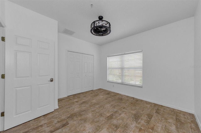 5030 Herring Ct, New Port Richey, FL 34652 - unfurnished bedroom with baseboards and a closet