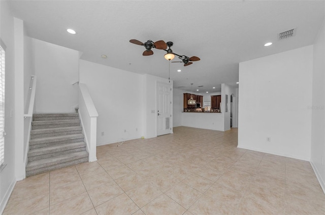 5030 Herring Ct, New Port Richey, FL 34652 - unfurnished living room with a ceiling fan, recessed lighting, stairway, and light tile patterned floors