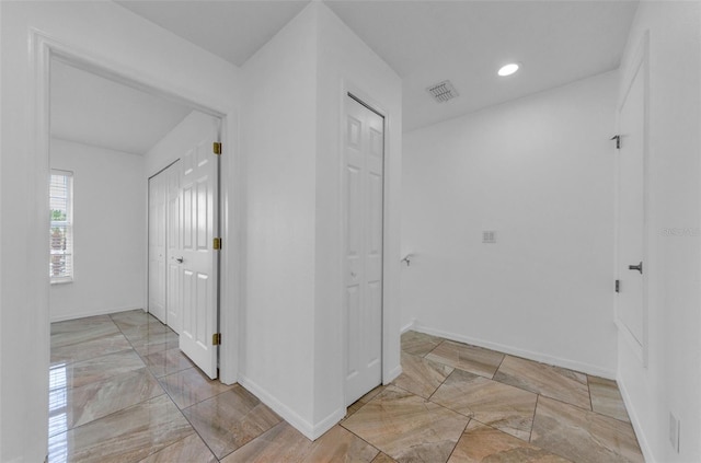 5030 Herring Ct, New Port Richey, FL 34652 - hall with marble tiled flooring and recessed lighting