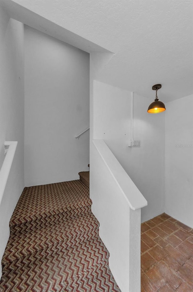 5030 Herring Ct, New Port Richey, FL 34652 - staircase with a textured ceiling