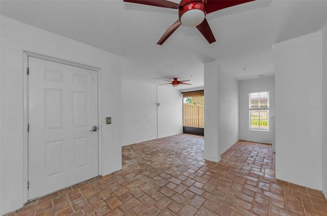 5030 Herring Ct, New Port Richey, FL 34652 - unfurnished room with ceiling fan and brick flooring