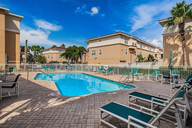 5030 Herring Ct, New Port Richey, FL 34652 - community pool featuring a patio and a residential view