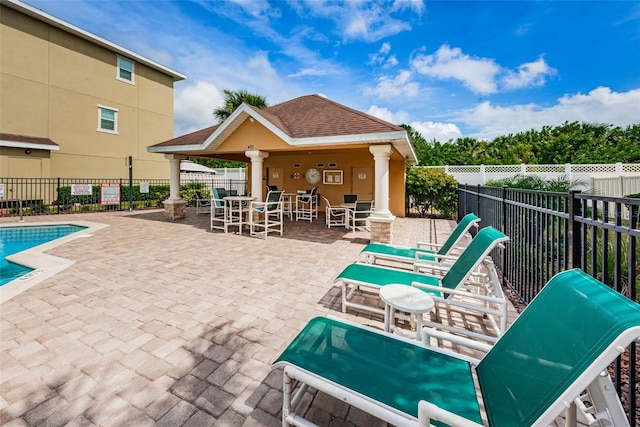 5030 Herring Ct, New Port Richey, FL 34652 - community pool featuring a patio, a fenced backyard, a gazebo, and outdoor dining space