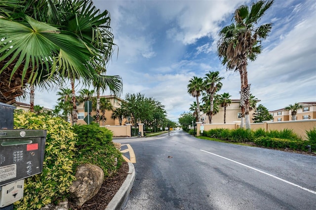 5030 Herring Ct, New Port Richey, FL 34652 - view of asphalt street with a residential view and a gated entry