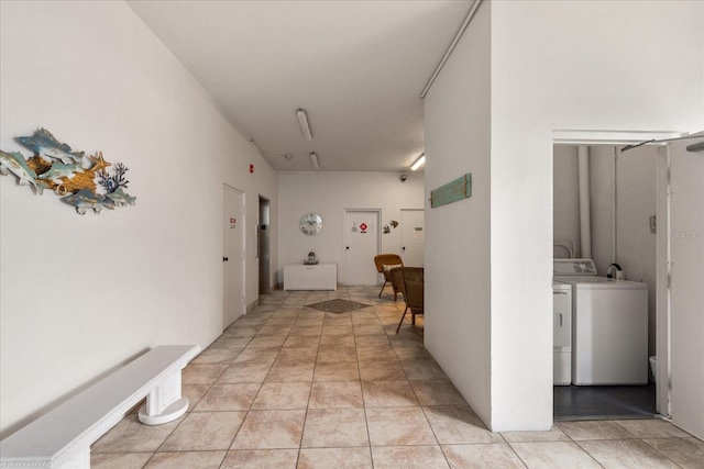 139 Bluff View Dr Unit 405, Belleair Bluffs, FL 33770 - hallway with washer and clothes dryer and light tile patterned flooring