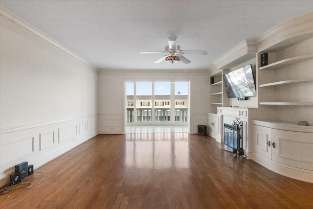 139 Bluff View Dr Unit 405, Belleair Bluffs, FL 33770 - unfurnished living room featuring a glass covered fireplace, ceiling fan, ornamental molding, wood finished floors, and a decorative wall