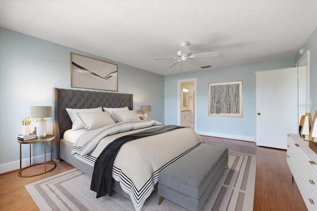 139 Bluff View Dr Unit 405, Belleair Bluffs, FL 33770 - bedroom featuring wood finished floors, a ceiling fan, and ensuite bathroom