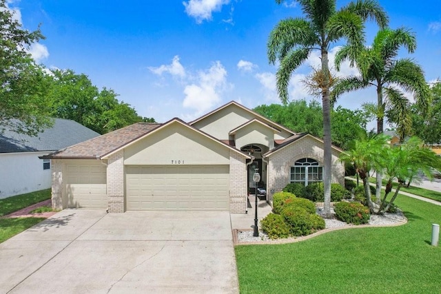 7101 Bucks Ford Dr, Riverview, FL 33578 - single story home with an attached garage, brick siding, a front yard, and concrete driveway