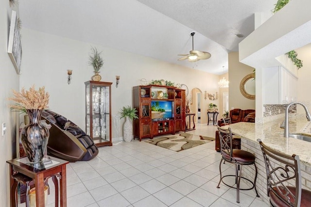 7101 Bucks Ford Dr, Riverview, FL 33578 - living area featuring a ceiling fan, vaulted ceiling, light tile patterned flooring, and arched walkways