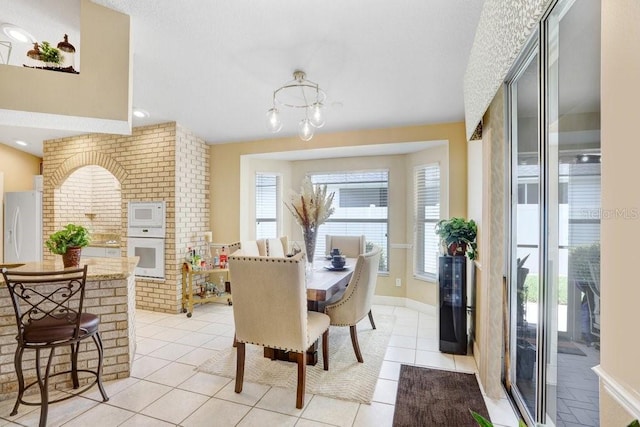 7101 Bucks Ford Dr, Riverview, FL 33578 - dining room featuring light tile patterned floors and a chandelier