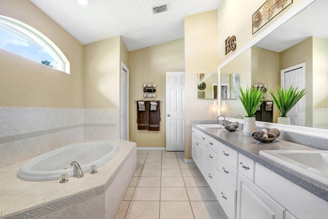 7101 Bucks Ford Dr, Riverview, FL 33578 - bathroom featuring double vanity, a garden tub, and tile patterned floors