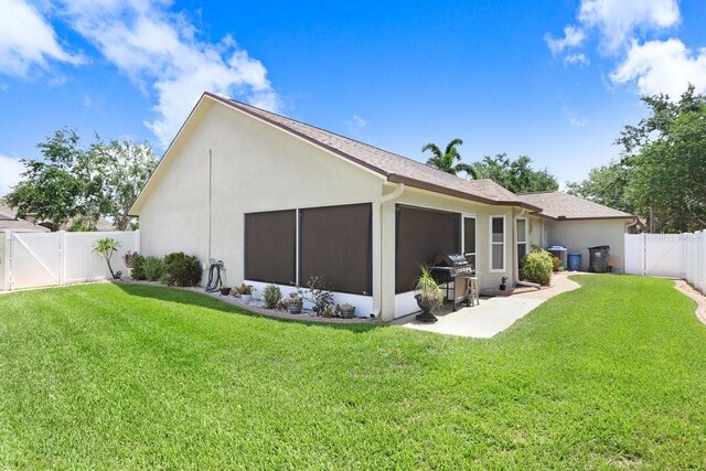 7101 Bucks Ford Dr, Riverview, FL 33578 - back of house with a fenced backyard, stucco siding, and a gate