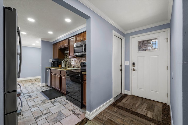 5346 Black Pine Dr, Tampa, FL 33624 - kitchen with appliances with stainless steel finishes, tasteful backsplash, crown molding, recessed lighting, and light countertops