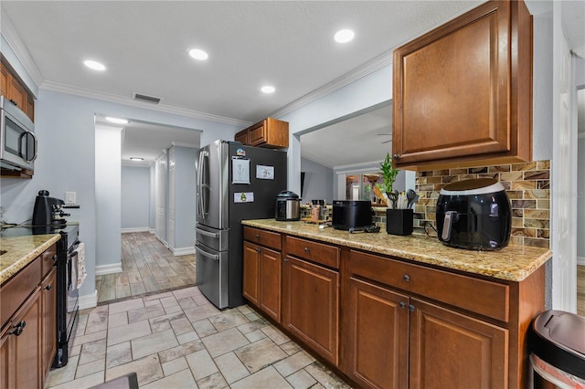 5346 Black Pine Dr, Tampa, FL 33624 - kitchen with stainless steel appliances, ornamental molding, brown cabinetry, backsplash, and light stone countertops