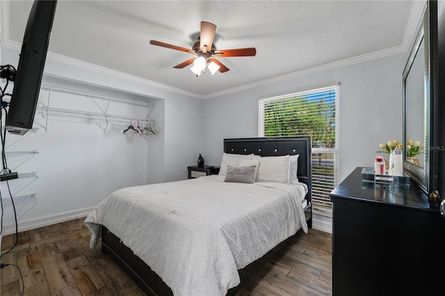 5346 Black Pine Dr, Tampa, FL 33624 - bedroom featuring dark wood-style floors, crown molding, ceiling fan, and a textured ceiling