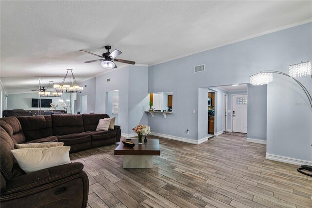 5346 Black Pine Dr, Tampa, FL 33624 - living area featuring a chandelier, a ceiling fan, wood finished floors, ornamental molding, and a textured ceiling