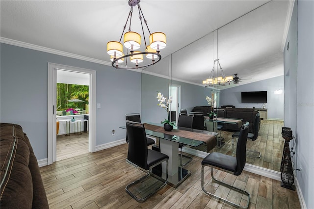 5346 Black Pine Dr, Tampa, FL 33624 - dining room featuring a chandelier, wood finished floors, ornamental molding, and vaulted ceiling
