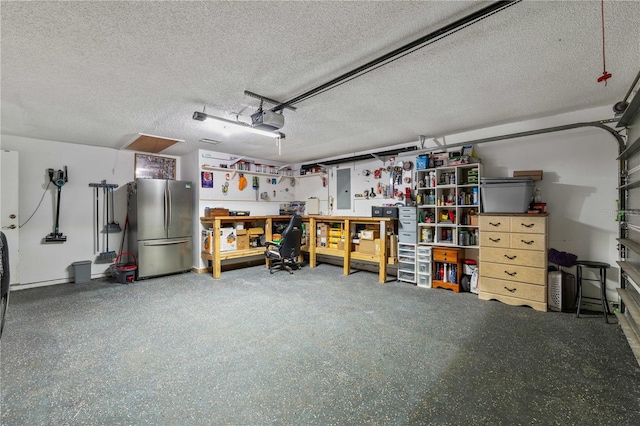 5346 Black Pine Dr, Tampa, FL 33624 - garage with freestanding refrigerator, a workshop area, and a garage door opener