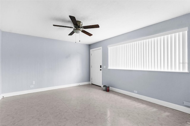 9310 N 12th St, Tampa, FL 33612 - empty room with a ceiling fan and baseboards