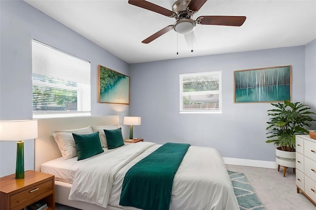 9310 N 12th St, Tampa, FL 33612 - bedroom with multiple windows, light carpet, and ceiling fan