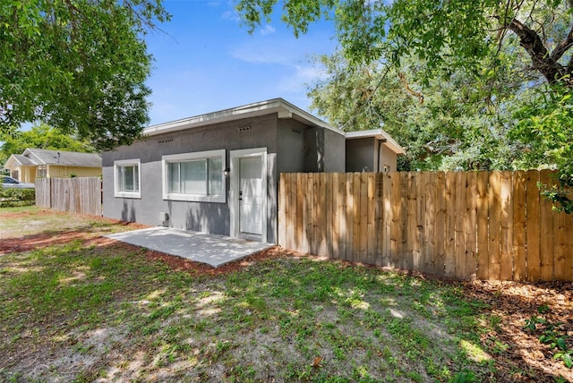 9310 N 12th St, Tampa, FL 33612 - back of house with stucco siding and a patio
