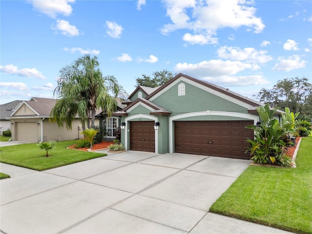 4512 Pointe O Woods Dr, Wesley Chapel, FL 33543 - ranch-style home with stucco siding, a garage, a front yard, and concrete driveway
