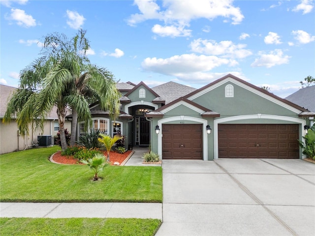 4512 Pointe O Woods Dr, Wesley Chapel, FL 33543 - view of front of home with an attached garage, driveway, stucco siding, a front yard, and roof with shingles