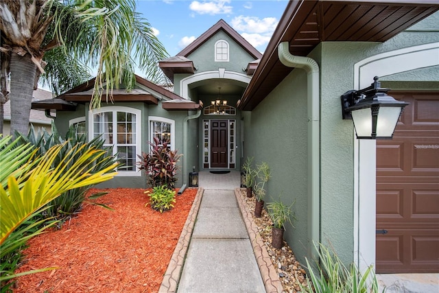 4512 Pointe O Woods Dr, Wesley Chapel, FL 33543 - view of exterior entry featuring stucco siding and an attached garage