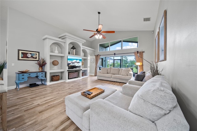 4512 Pointe O Woods Dr, Wesley Chapel, FL 33543 - living area featuring wood finished floors, ceiling fan, high vaulted ceiling, and built in features