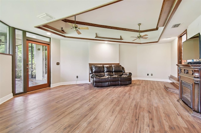 2103 N Golfview Dr, Plant City, FL 33566 - living area featuring ceiling fan, a tray ceiling, light wood-style floors, and crown molding